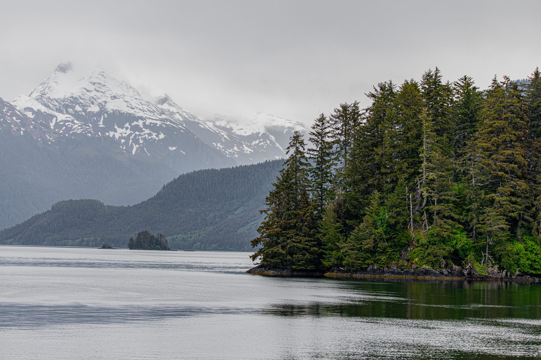 Mist over forested islands and mountains · Alaska