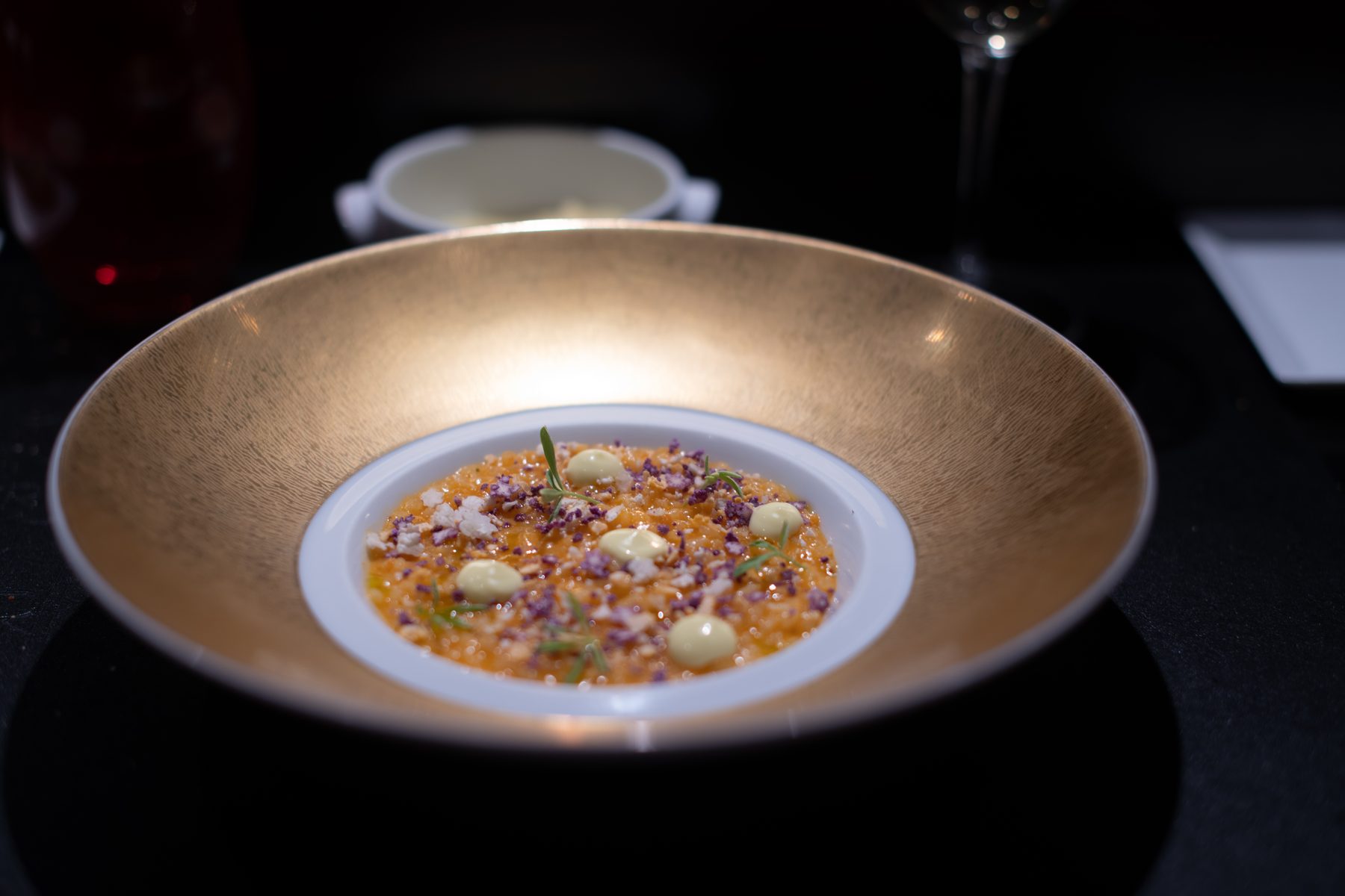 Fine dining course served in a gold bowl · Paris
