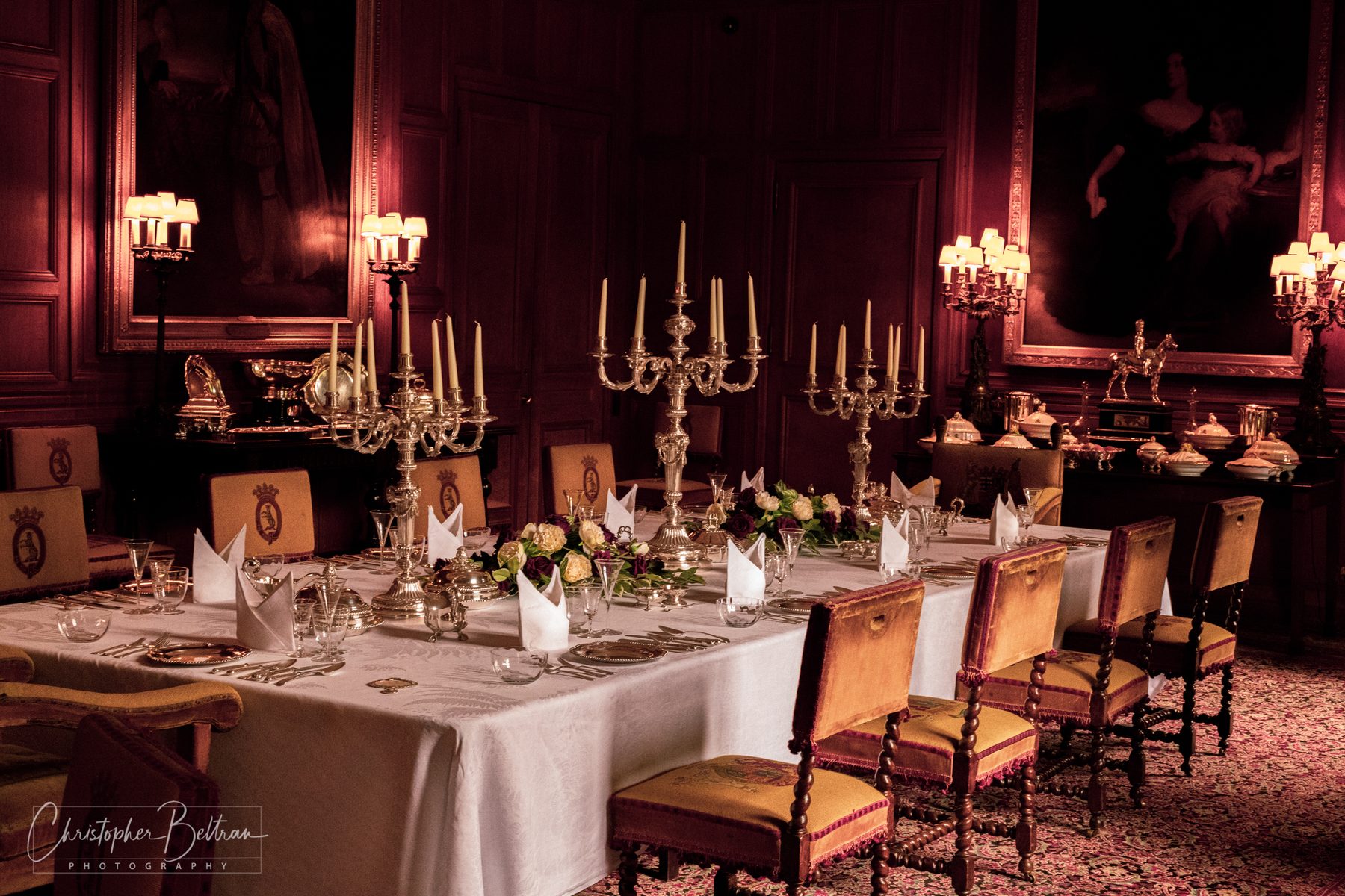 Candlelit castle dining room set for dinner · Scotland