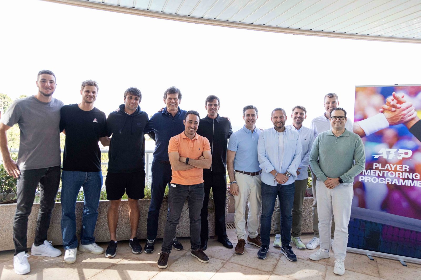 Mentors and players on a terrace above the Mediterranean
