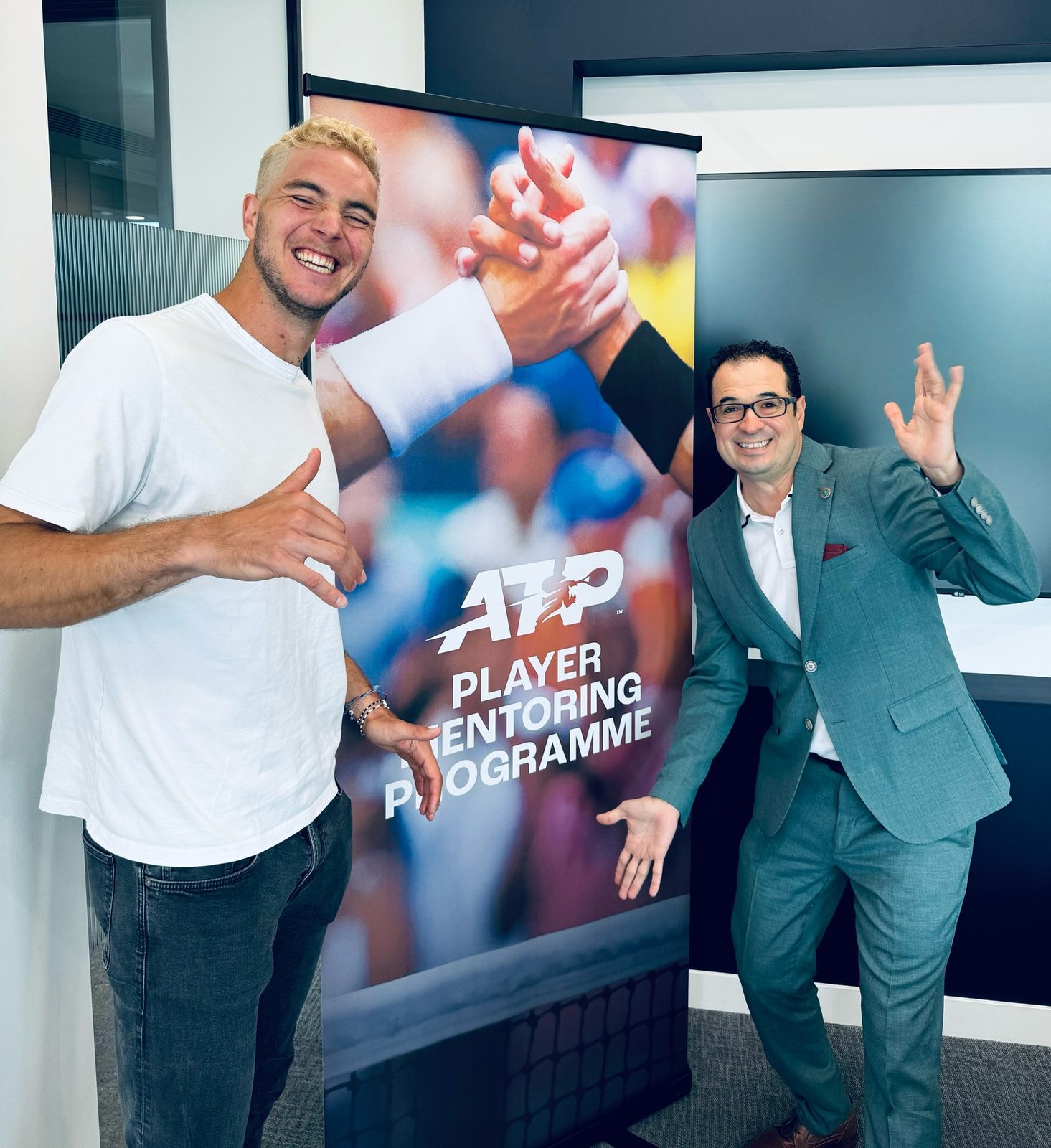Christopher Beltran with a player at the ATP Player Mentoring Programme launch banner