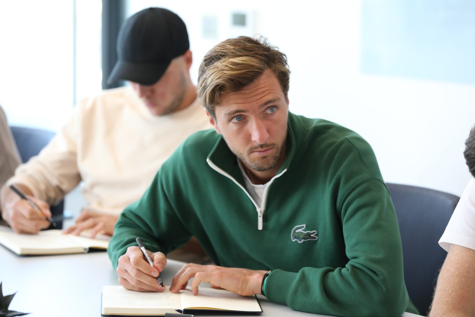 A player writing during a mentoring workshop session