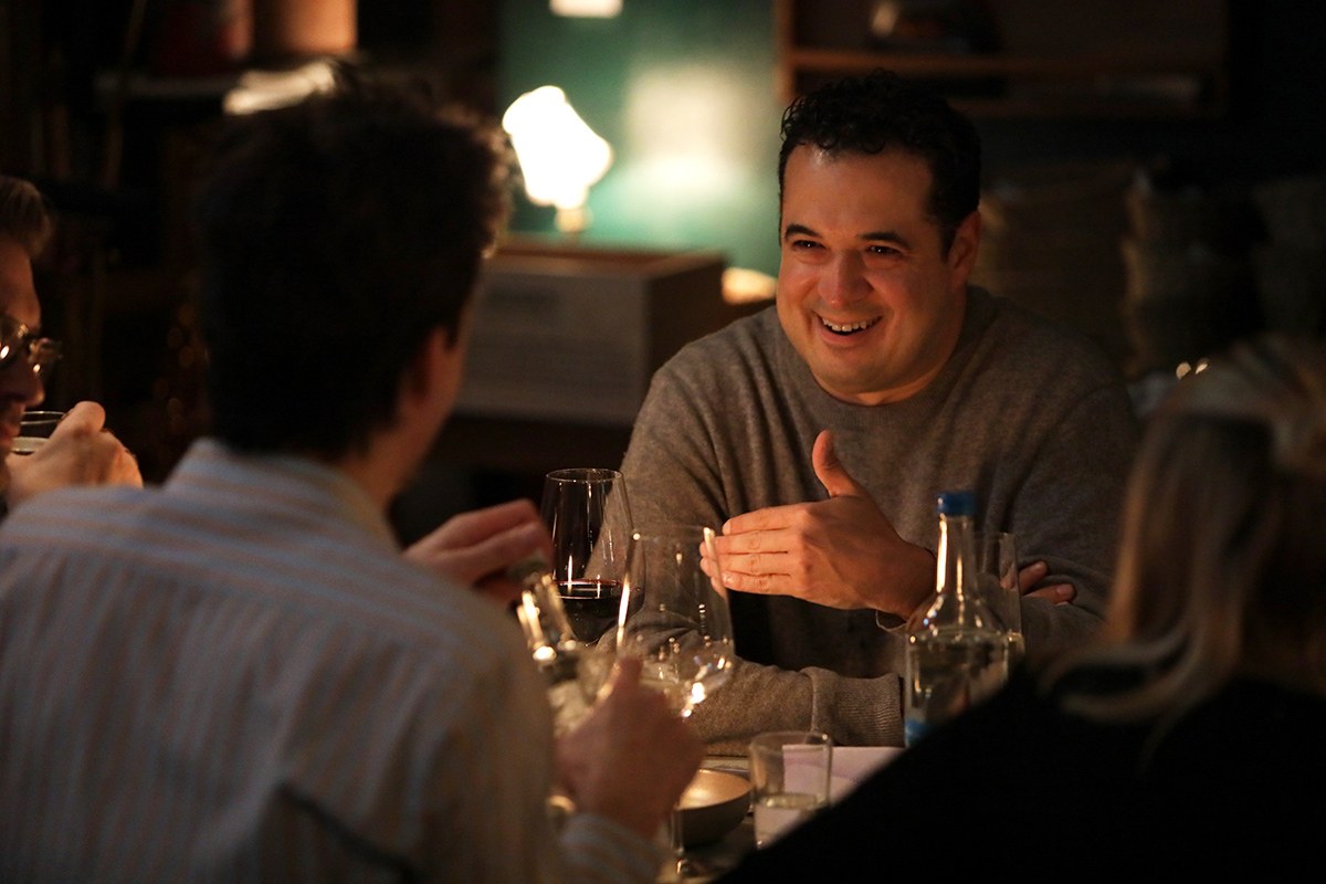 Christopher Beltran in conversation over dinner